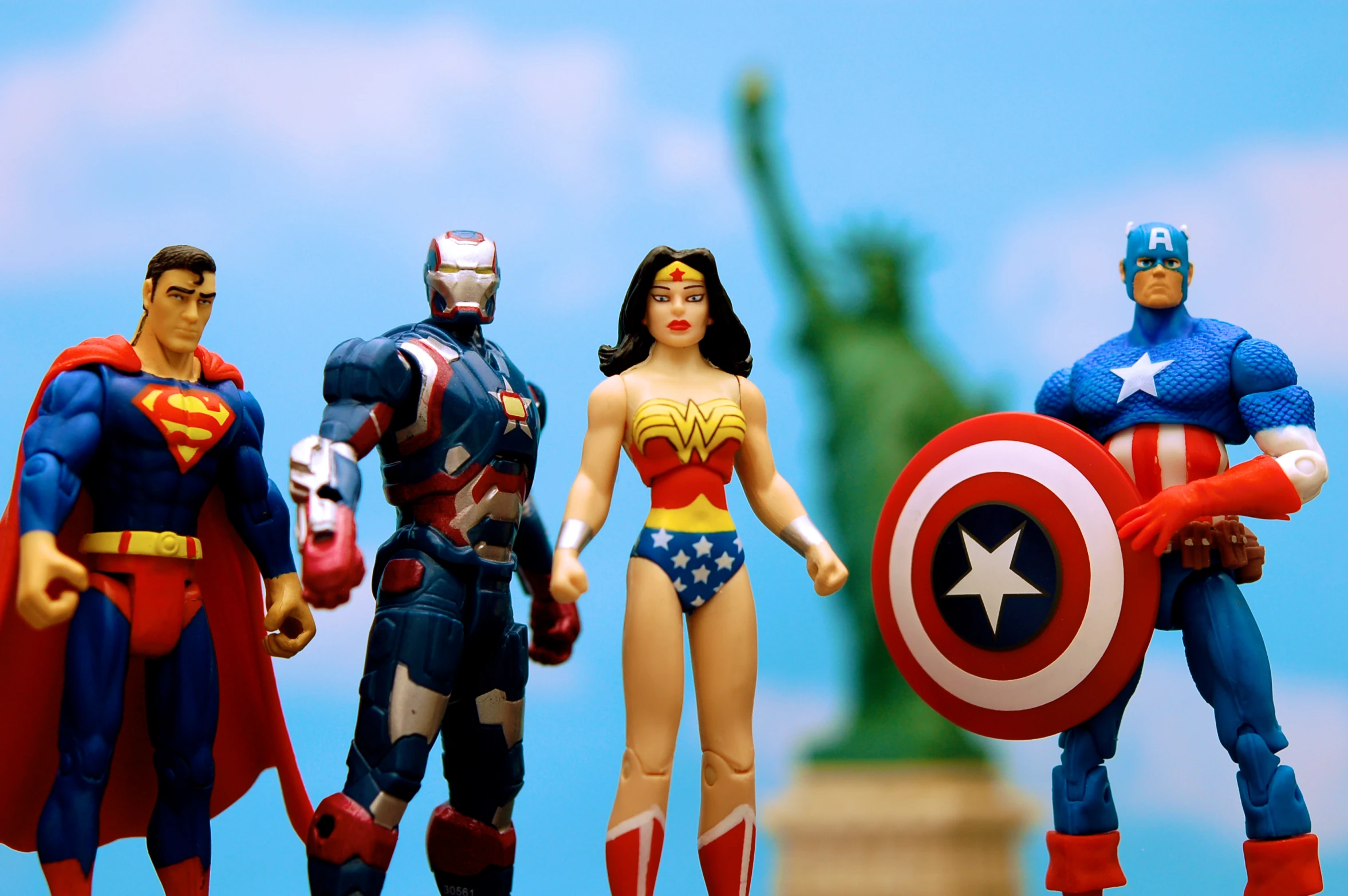 three action figures from the batman, captain america and wonder woman