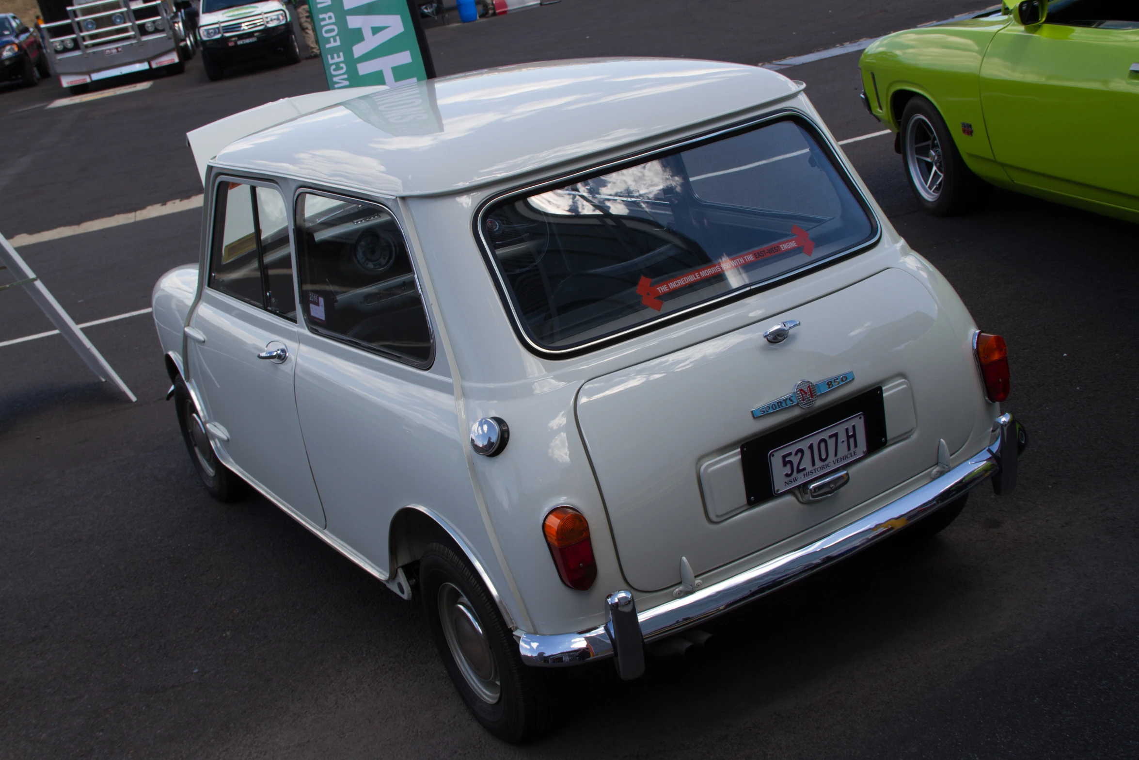 an old small car with a sign on top