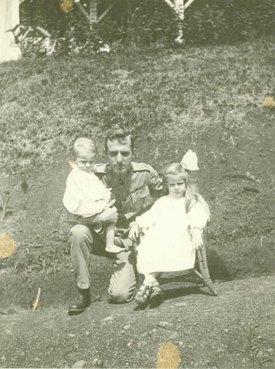 old black and white po of family with a cat on the lawn