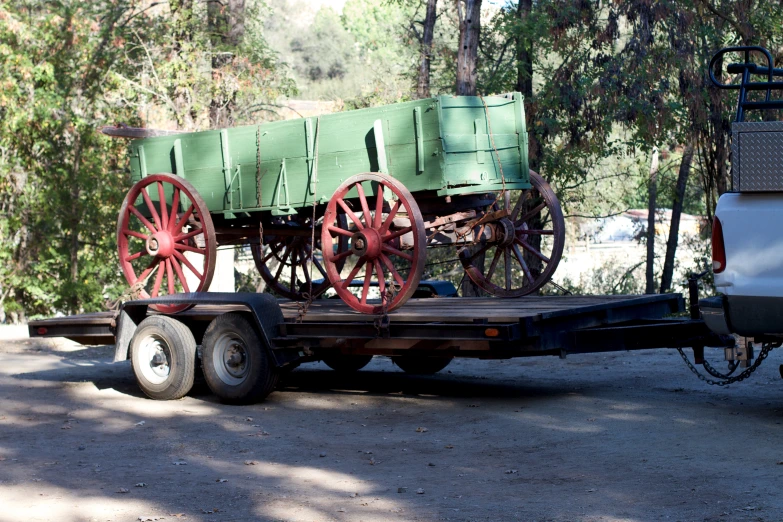 an old horse drawn wagon with some wheels on the back