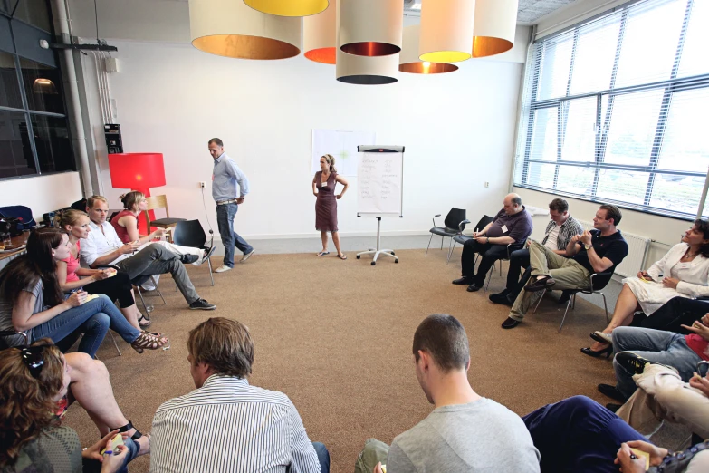 a woman giving a presentation to a group of people