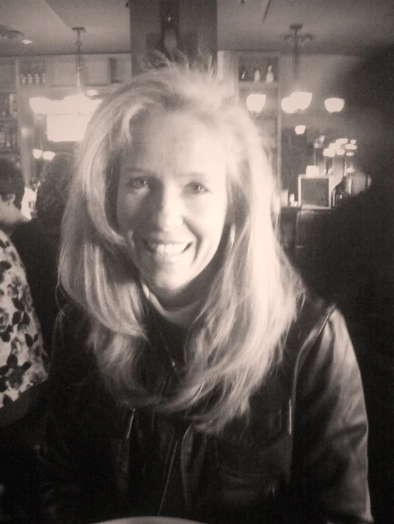 black and white image of a woman at a diner