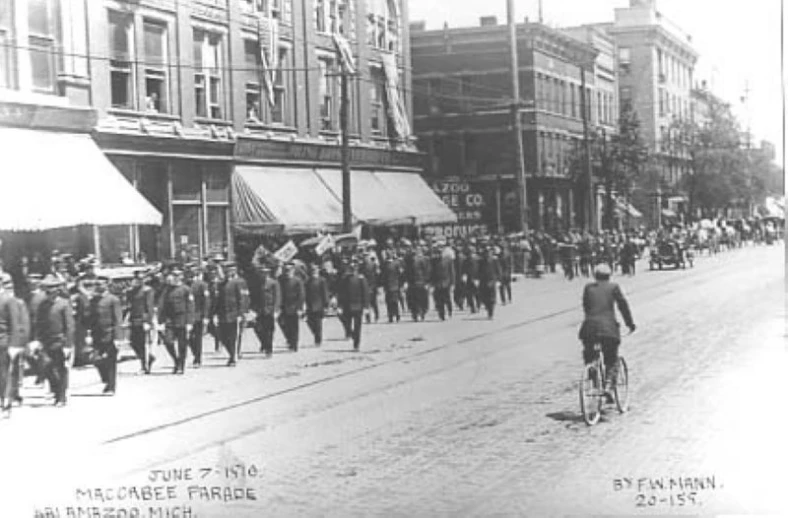 old po of military men riding on bikes in street