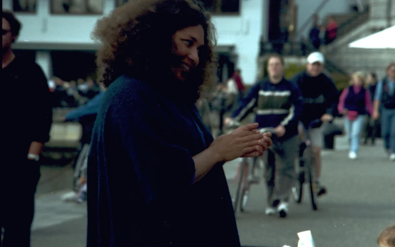 a man with curly hair and beard talking on a phone