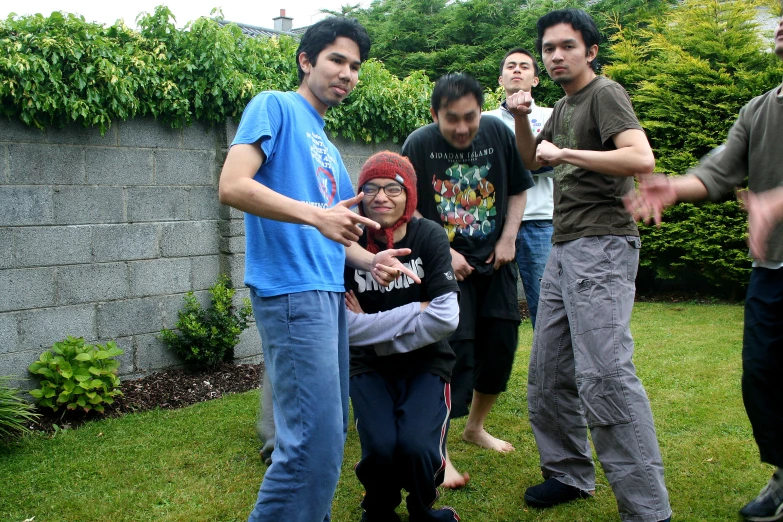 a group of people pose for a po in the grass
