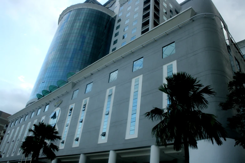 a tall building that is standing near a bunch of trees