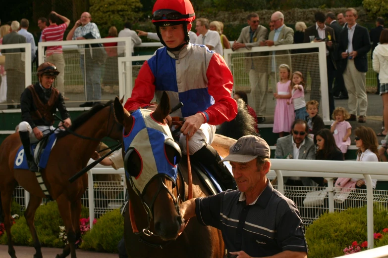 a man riding on the back of a horse next to another man