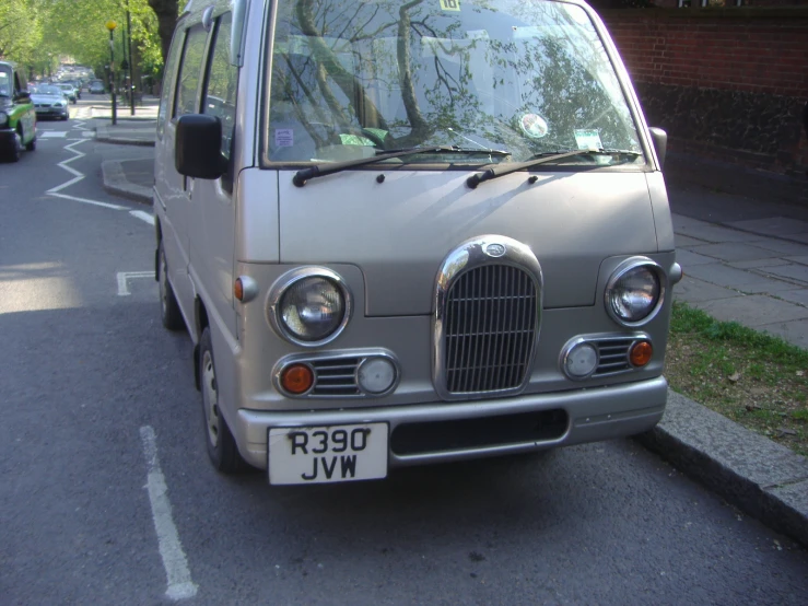 the small van is parked on the side of the road