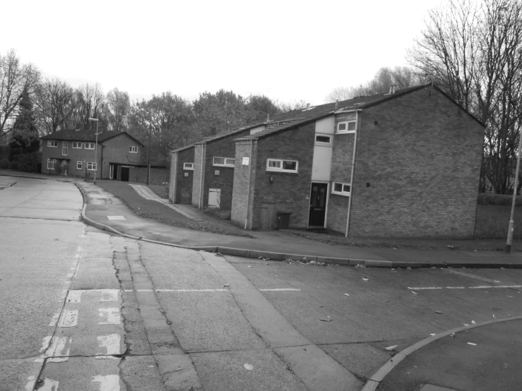 black and white pograph of street in front of buildings