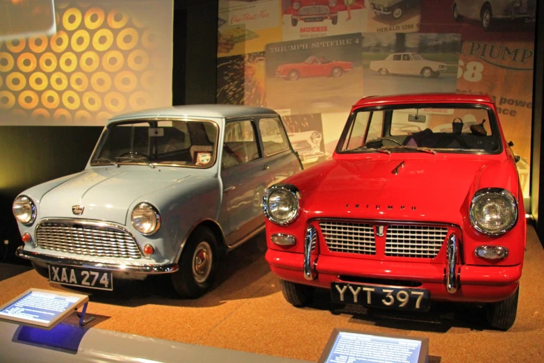 two cars sit in front of an advertit