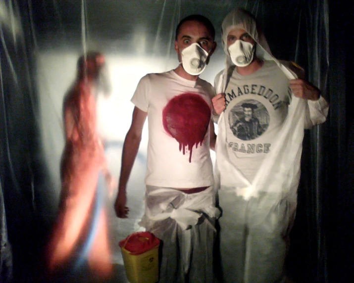 two people in costumes with white paint on them