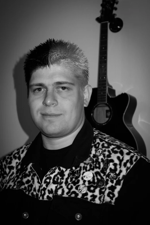 a black and white po of a man holding a guitar