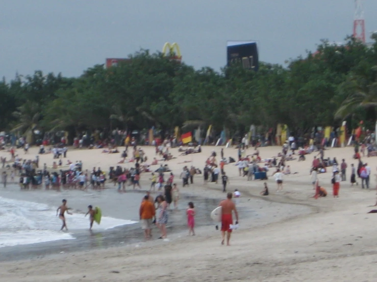 many people walking on the beach at daytime