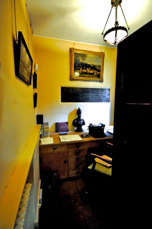 the hallway leading to a home office with yellow walls