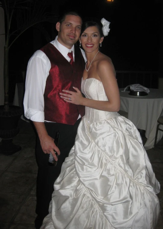 a couple dressed in formal wear posing for a po