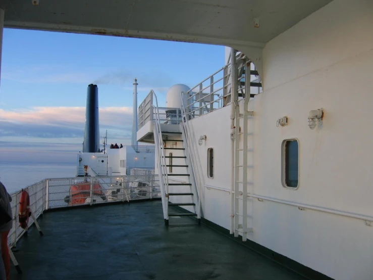 white boat with stairs and two people on board