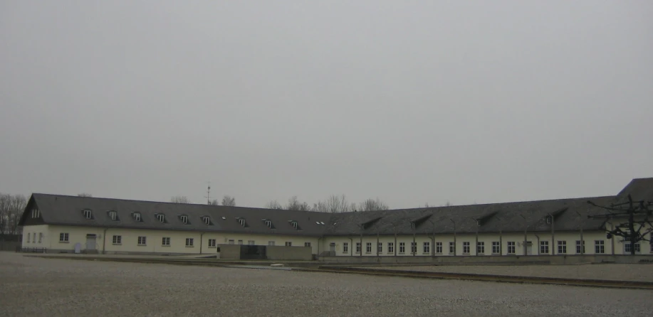 a white building that has a red and black clock on top