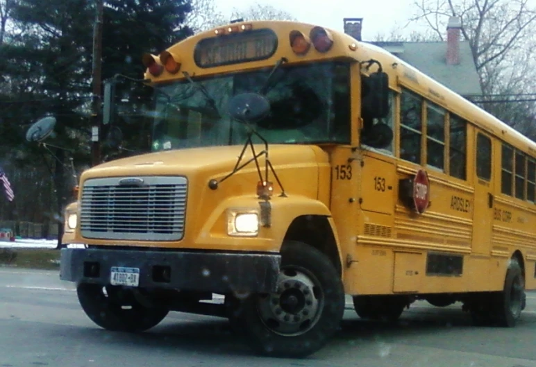 a school bus sits parked on the side of a road