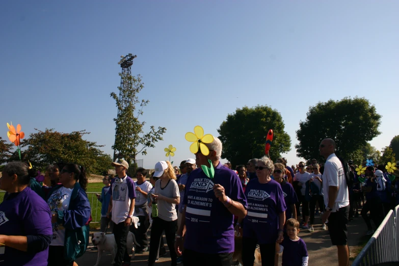 the people are standing together near many trees