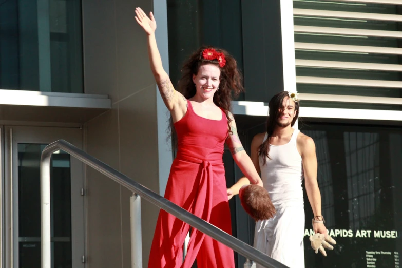 two woman walking down a stair way while wearing red and white