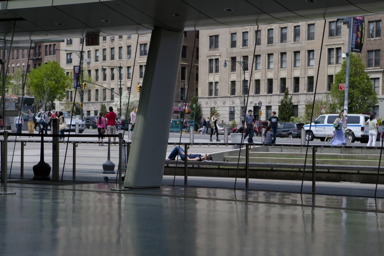 several people walking and sitting near a sidewalk