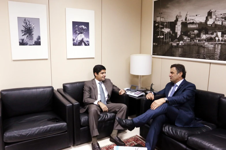 two men sitting in a room during a conversation