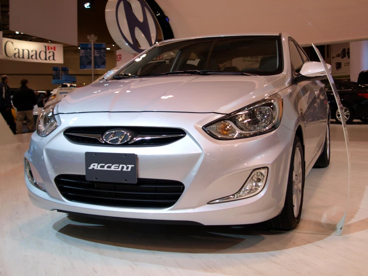 a silver car is on display at an auto show