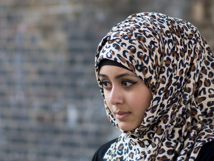 a close up of a person wearing a head scarf