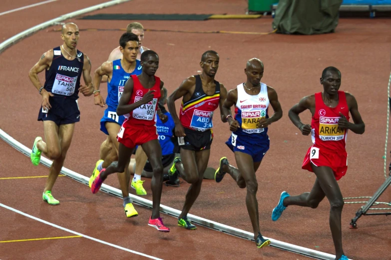 a number of athletes on a track running towards each other