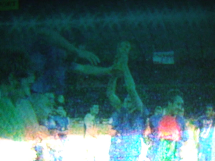 the basketball player is jumping in the air while people watch