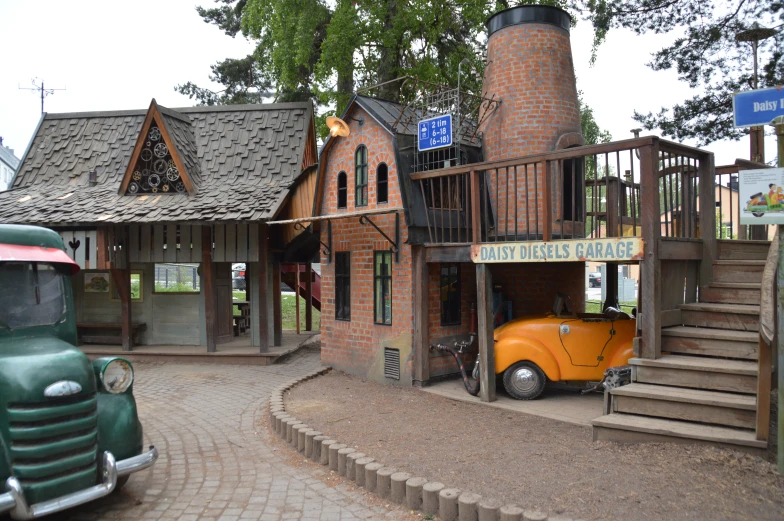 a building with a playground and a car in front