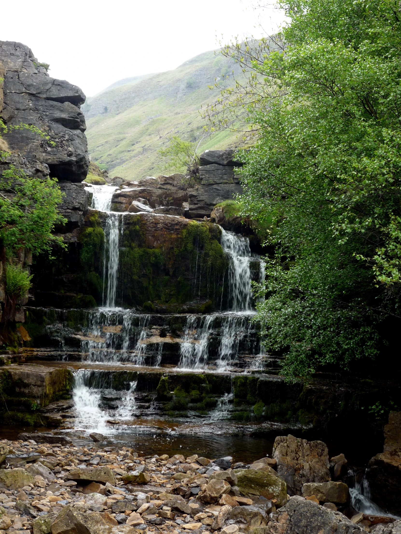 a waterfall that is in the middle of some rocks