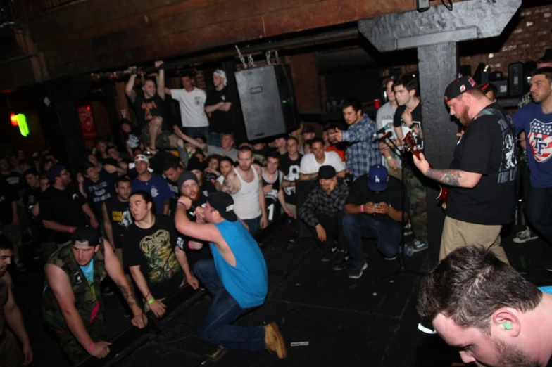 group of men in a crowded room with one male dancing