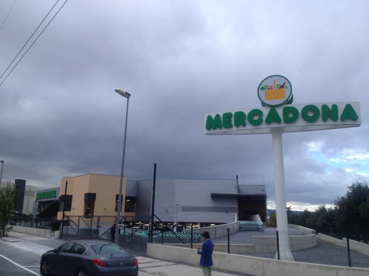 an intersection with cars in front of an advertiser's store