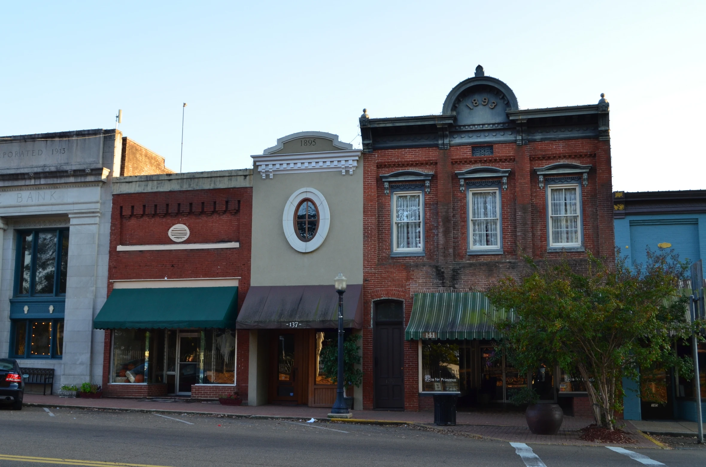 a town street with buildings and a truck