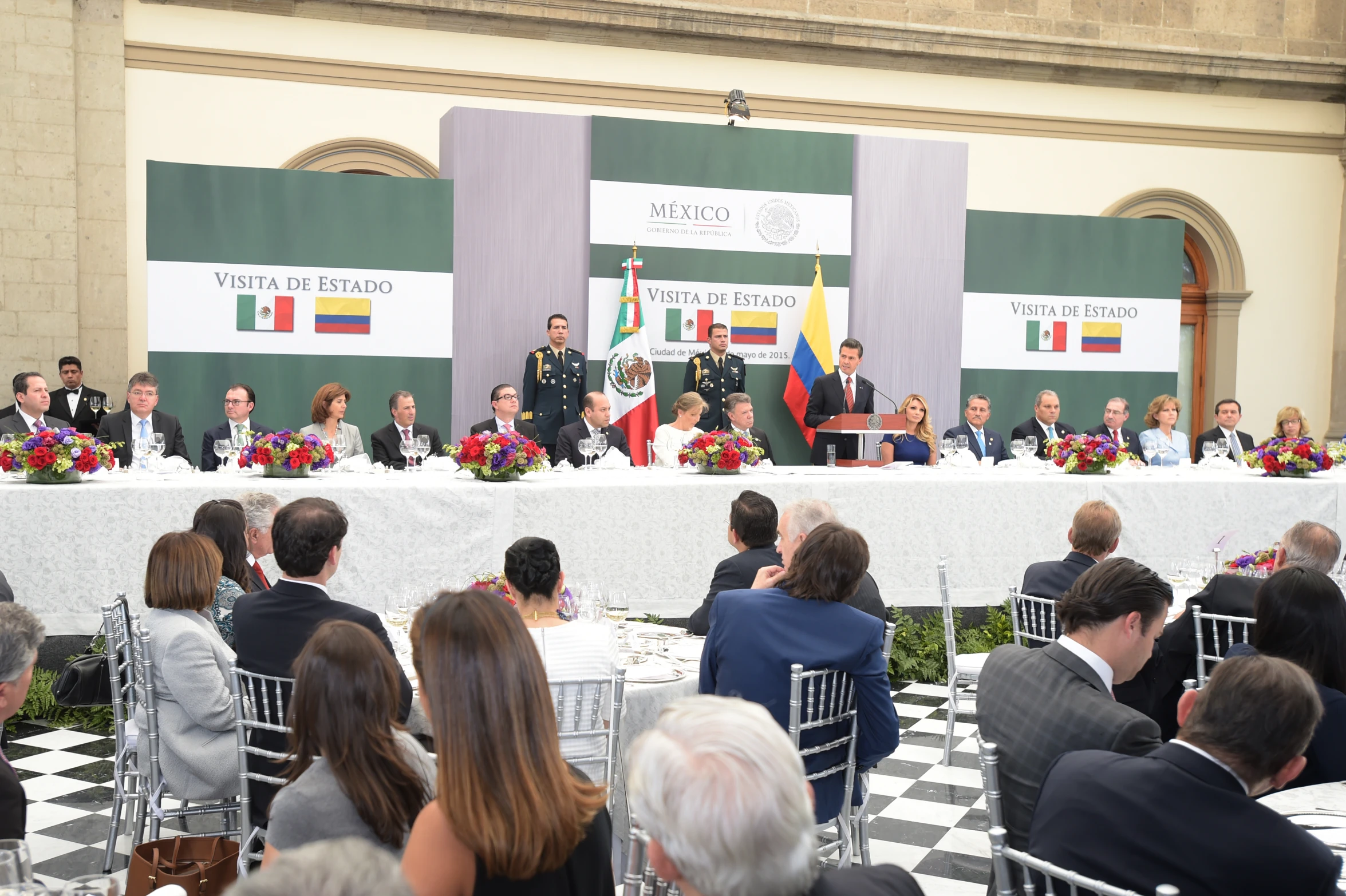 several people in formal wear sitting at a table