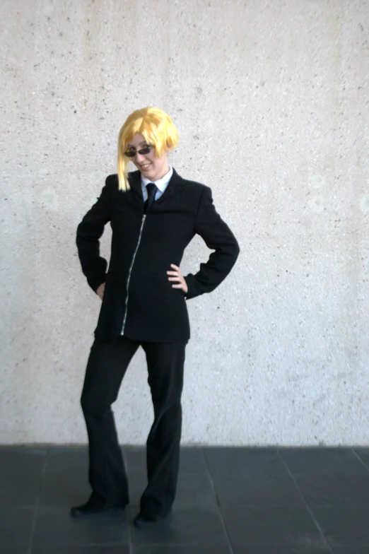 a woman wearing sunglasses and a suit with yellow hair