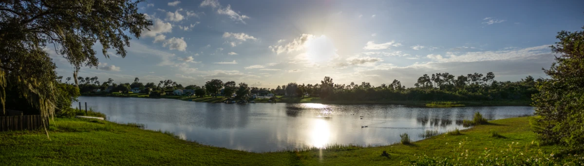 the sun is shining over a lake with water