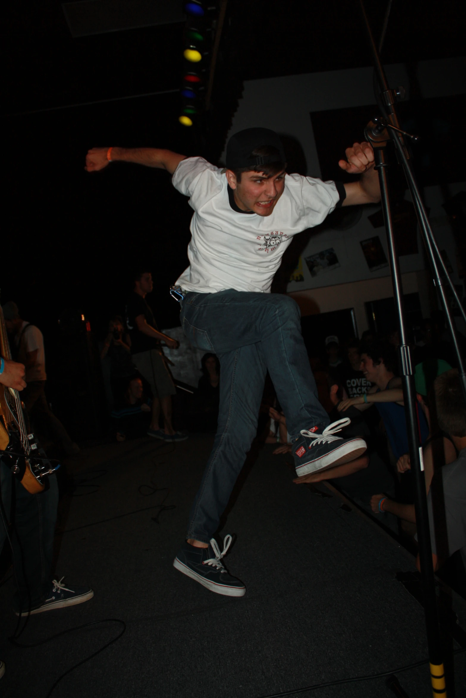 the skateboarder is balancing on the railing in the dark