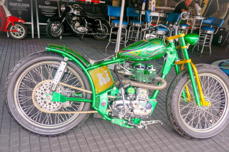 a green and yellow dirt bike on display at a show