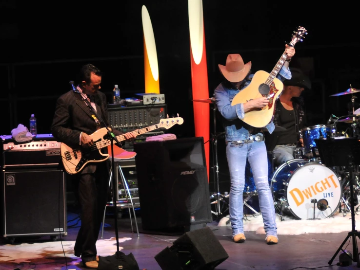 a man and woman play guitar on stage