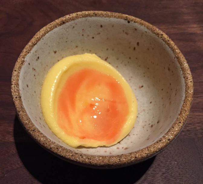 a bowl filled with an egg and cream