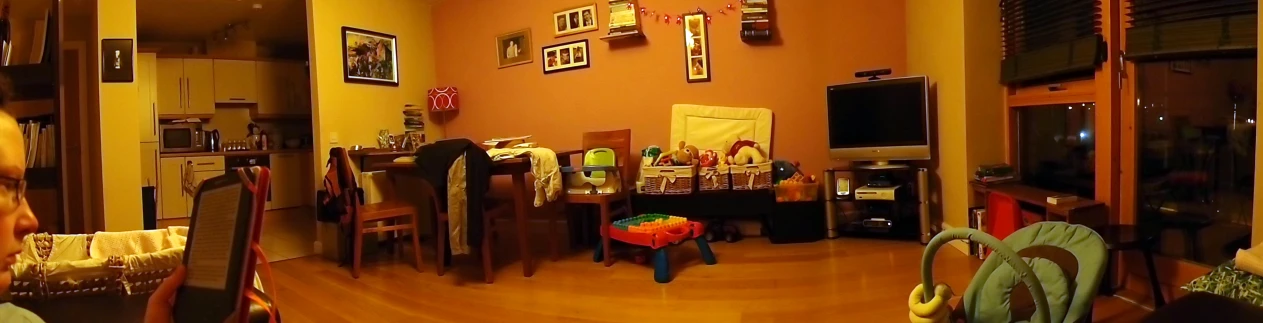 a living room with chairs and a wall mounted clock