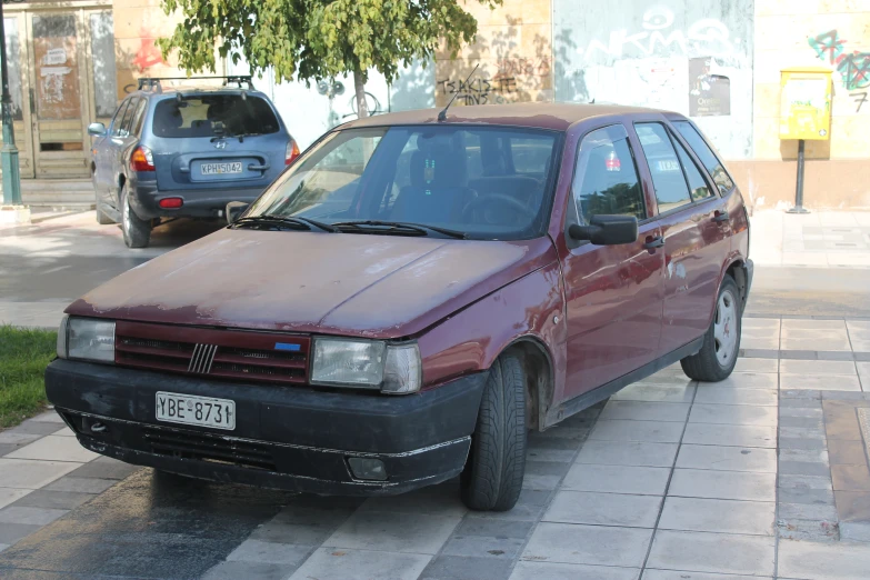 a car parked near a curb next to a sidewalk