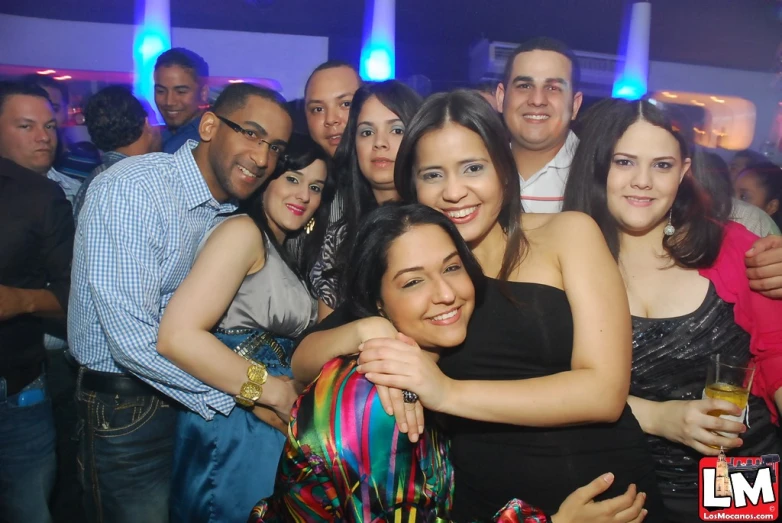 several people posing for a picture at a nightclub