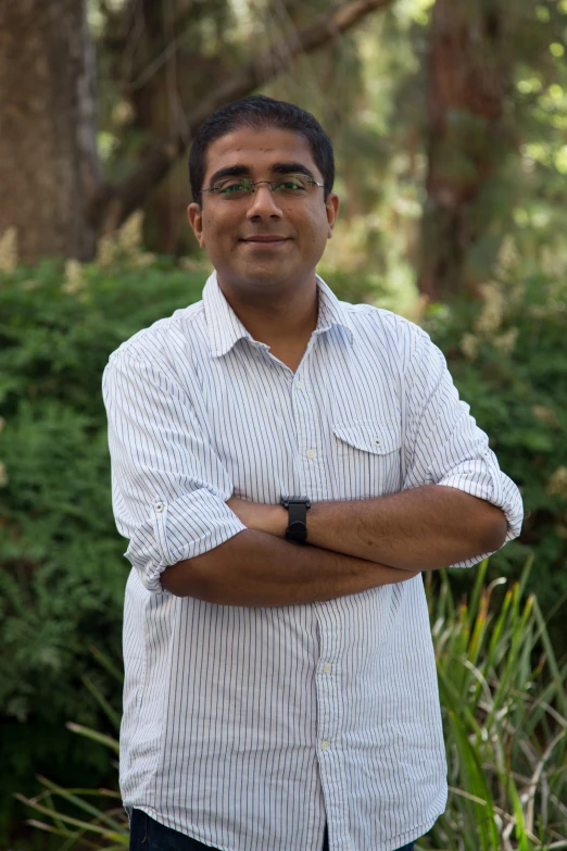 a man in a white shirt is smiling for the camera