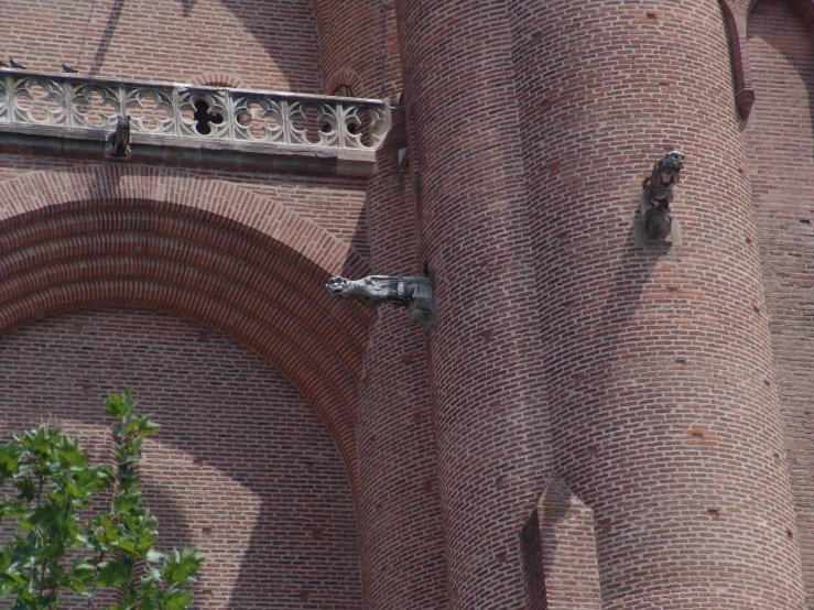 two bird holes in the brick wall of a building