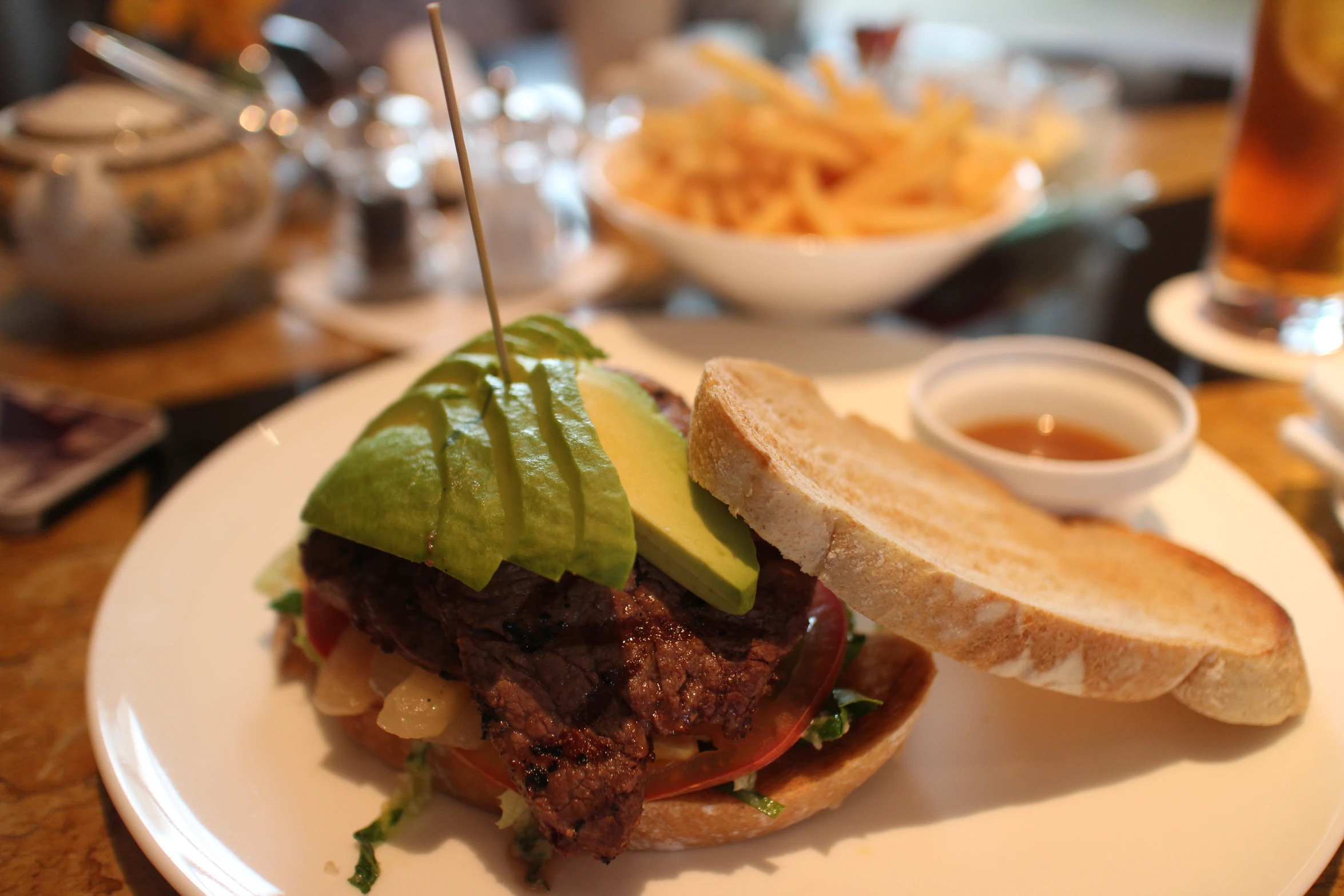 a steak sandwich with a side of potato fries