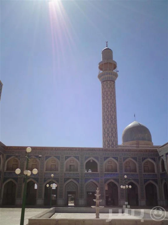 the courtyard of a building with a tall tower