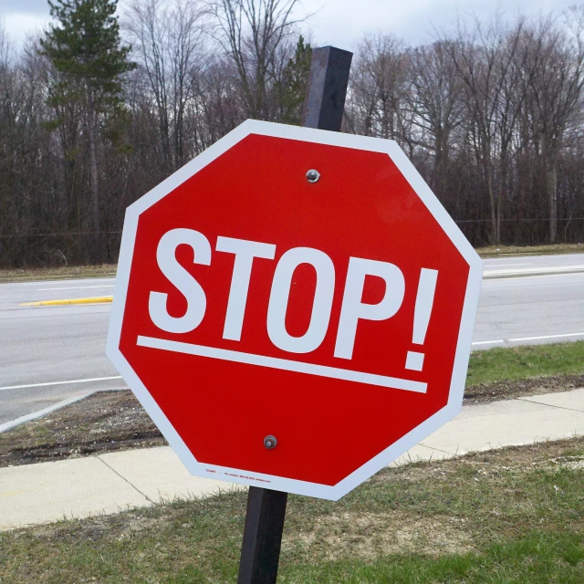 a stop sign with the words stop on it by the street